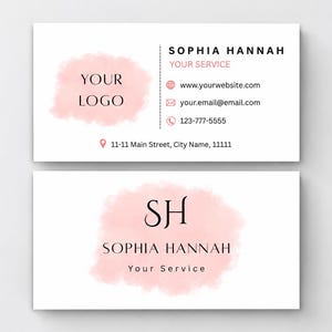 May include: Two white business cards featuring a soft pink watercolor splash design. The top card displays the name Sophia Hannah, Your Service, contact icons, and address. The bottom card features the initials SH, the name, and Your Service.