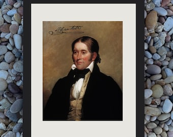 May include: Framed portrait of a man in a black coat and white shirt. The portrait has a signature in the upper left corner. The background is a neutral color. The frame is black.