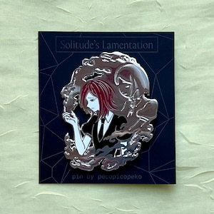 May include: A silver-colored enamel pin featuring a character with red hair and a black suit, surrounded by a stylized cloud design. The pin is on a dark blue card with the text "Solitude's Lamentation" and "pin by pecopicopeko".