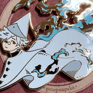 May include: A gold-colored enamel pin featuring a cartoon character with white hair and a hat, riding a stylized wave. The wave has blue accents. The pin has the text "pecopicopeko".