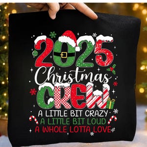 May include: Black pillow with the text "2025 Christmas CREW" in red, green, and white. The design includes snowflakes, candy canes, and the phrases "A LITTLE BIT CRAZY, A LITTLE BIT LOUD, A WHOLE LOTTA LOVE."