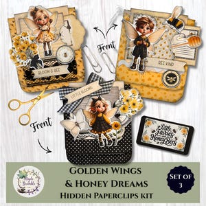 May include: A set of three decorative paperclip kits with a fairy theme. Each kit features a unique design with fairy illustrations, floral accents, and the text "Bloom & Bee", "Bee Kind", and "Little Blooms". The kits are adorned with paperclips and scissors.