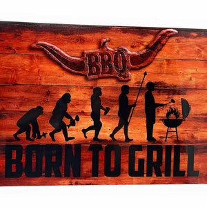May include: A rustic wooden sign with a silhouette of a cowboy hat with the word "BBQ" on it.  The sign also features a line of stick figures representing the evolution of man, ending with a man grilling. The text "BORN TO GRILL" is printed in black at the bottom of the sign.