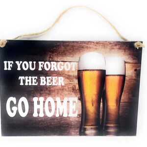 May include: A wooden sign with a rustic brown background and the text "If you forgot the beer go home" in white letters. Two glasses of beer are pictured in front of the text.