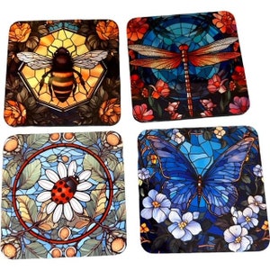 May include: Set of four square coasters featuring stained glass style designs of a bee, dragonfly, ladybug, and butterfly. Each coaster has a blue, green, and yellow background with floral accents.