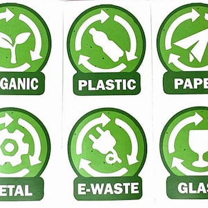 May include: Six green and white circular stickers with arrows in a circle. The stickers are labeled with the following words: ORGANIC, PLASTIC, PAPER, METAL, E-WASTE, and GLASS.