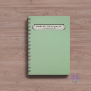 Minimalist medical care organizer spiral notebook mockup featuring simple sage green healthcare planning cover on a wood desk background.