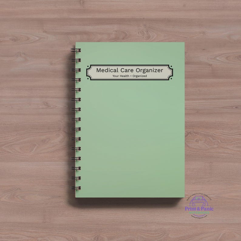 Minimalist medical care organizer spiral notebook mockup featuring simple sage green healthcare planning cover on a wood desk background.