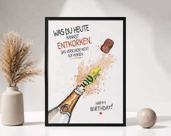 May include: A framed print featuring a champagne bottle popping with a 100 euro bill emerging from the neck and a cork flying above. The text reads: WAS DU HEUTE KANNST ENTKORKEN, DAS VERSCHIEBE NICHT AUF MORGEN and HAPPY BIRTHDAY! with a small red heart.