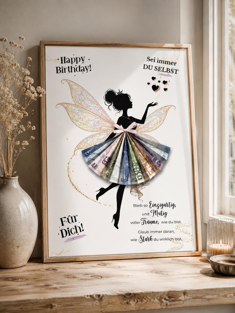 May include: A framed print featuring a black silhouette of a fairy with iridescent wings. The fairy's skirt is made of folded paper currency. The text reads: Happy Birthday! Sei immer DU SELBST, F&uuml;r Dich! Bleib so Einzigartig, und Mutig voller Tr&auml;ume, wie du bist. Glaub immer daran, wie Stark du wirklich bist.