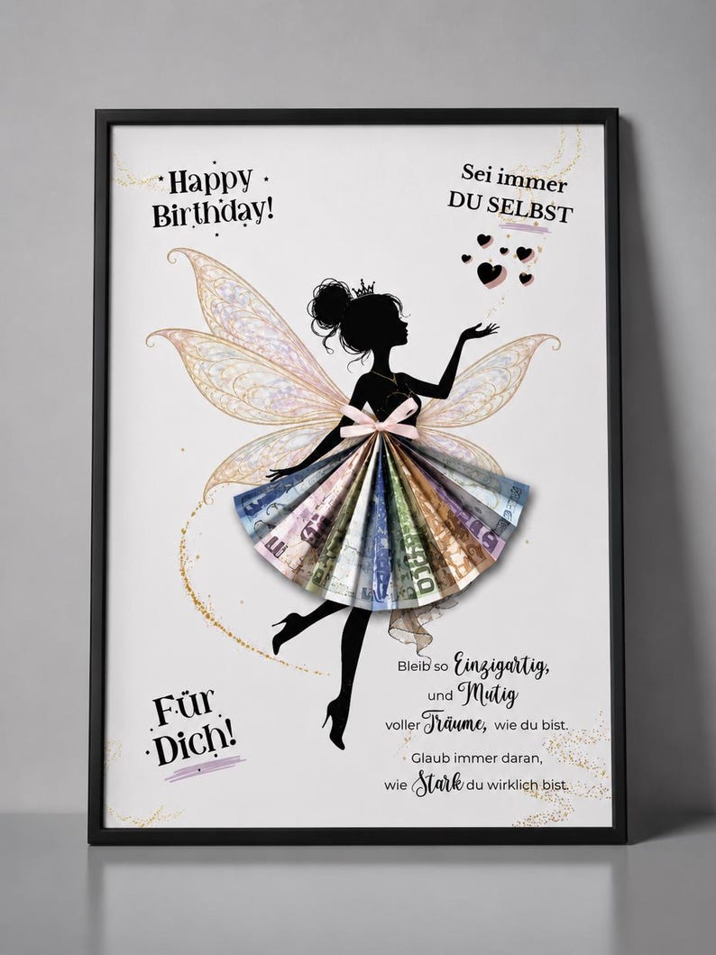 May include: A framed print featuring a black silhouette of a fairy with large, translucent wings. The fairy wears a skirt made of folded paper currency. The text reads Happy Birthday, Sei immer DU SELBST, F&uuml;r Dich, and other German phrases.