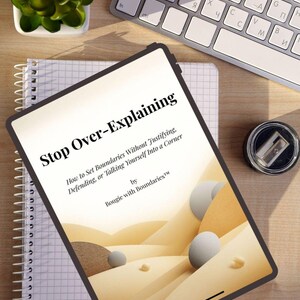 May include: A digital tablet displaying the book cover titled Stop Over-Explaining: How to Set Boundaries Without Justifying, Defending, or Talking Yourself Into a Corner by Bougie with Boundaries, featuring a graphic of abstract sand dunes.