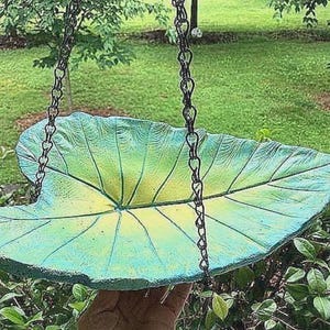 Unique outdoor hanging concrete elephant ear bird bath, hand painted, comes with black metal 3 chain hanger, no two alike. 15x10.
