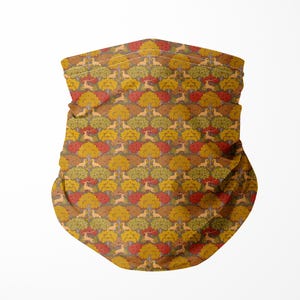 May include: A neck gaiter with a repeating pattern of stylized trees in shades of gold, red, and green. The fabric is folded, creating a textured appearance. The background is plain white.