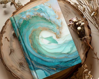 May include: A hardback journal with a vibrant ocean wave design in shades of teal, turquoise, and gold. The cover features an abstract illustration of a wave with a dolphin, creating a serene and artistic aesthetic.