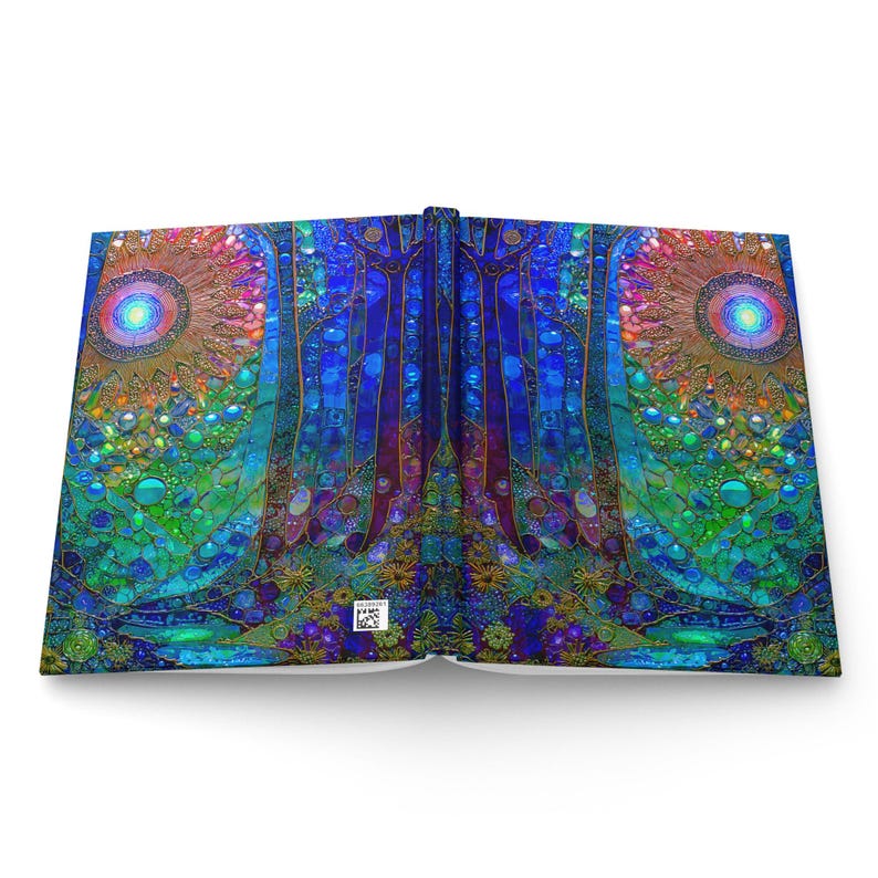 May include: A hardcover book laid open to display a vibrant, symmetrical mosaic-style illustration. The artwork features deep blue, teal, and green tones with two prominent circular sun-like motifs, intricate patterns, and a small white barcode.