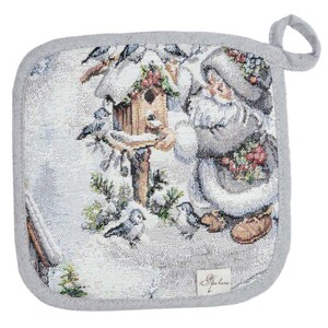 May include: Square, woven potholder with a winter scene featuring a person feeding birds near a birdhouse. The design is primarily white, gray, and brown, with a gray border and a loop for hanging. The potholder has a label in the lower right corner.
