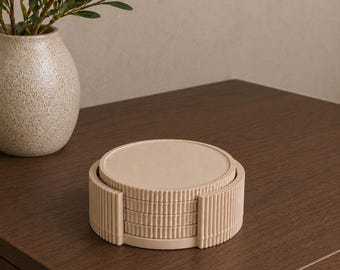 May include: A stack of four circular beige coasters with a ribbed, vertical texture along the edges, housed within a matching cylindrical holder that features the same consistent ribbed design around its exterior circumference.