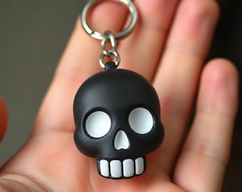 Chaveiro com pingente de caveira de obsidiana, acessório gótico pintado à mão, estilo único e sombrio.
