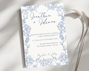 May include: A wedding invitation with a floral border in blue ink. The names "Jonathan + Juliana" are at the top, with event details below. The invitation is for a wedding celebration at the Borcelle Hotel & Ballroom.