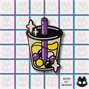 May include: A colorful enamel pin featuring a bubble tea design. The pin has a clear cup with yellow and purple liquid, and black and purple boba. The pin has a black rim and a purple straw. The pin has two glittery star accents. The text "Glitch Cat Graphics" is at the bottom.