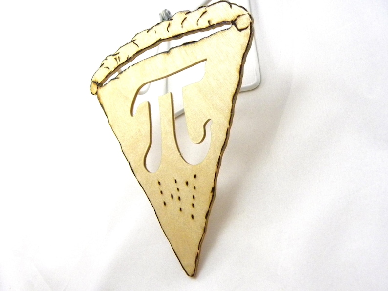 May include: A wooden pie slice ornament with the mathematical symbol pi cut out of the center. The ornament is light brown and has a rustic, hand-crafted look.