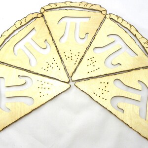 May include: Five wooden pie slices with the mathematical symbol pi cut out of each slice. The slices are arranged in a circle.