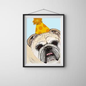 May include: Framed art print featuring a close-up of a bulldog wearing a yellow party hat with orange polka dots. The dog has a light tan and white coat, with a pink tongue sticking out. The background is light blue.