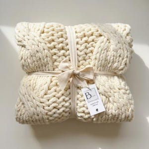 Luxury cable knit throw blanket in ivory, a personalized realtor client gift for buyers, closing day, and new home celebrations