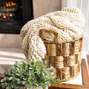 Customer photo of ivory cable knit blanket styled at home, luxury throw received as a realtor closing and housewarming gift