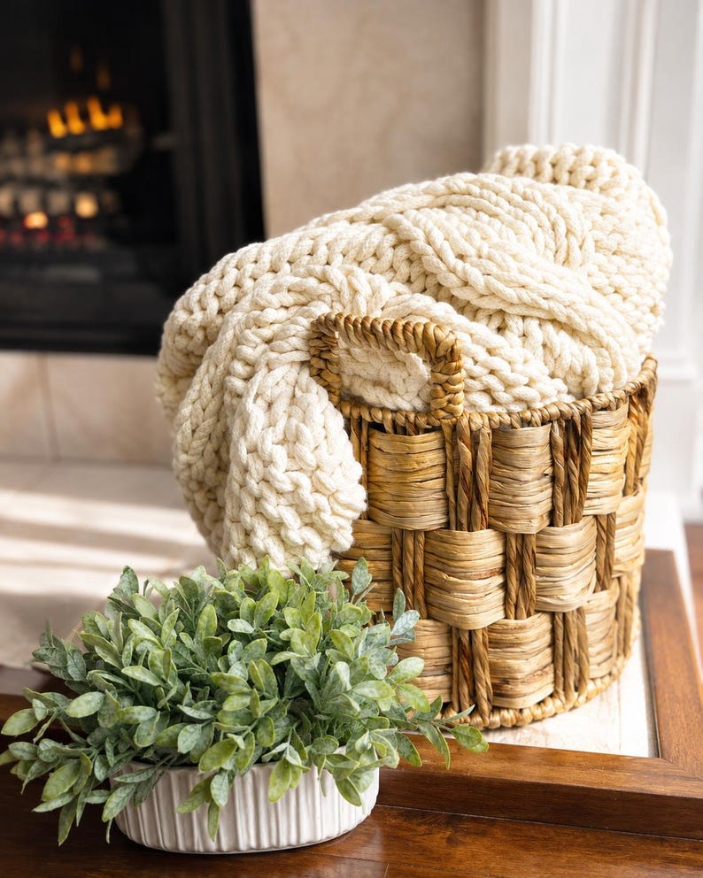 Customer photo of ivory cable knit blanket styled at home, luxury throw received as a realtor closing and housewarming gift