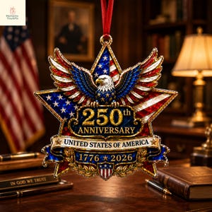 May include: A star-shaped commemorative ornament featuring a bald eagle with spread wings, coloured in red, white, and blue. The text reads 250th ANNIVERSARY UNITED STATES OF AMERICA 1776-2026. It hangs from a red ribbon with a metallic gold finish.
