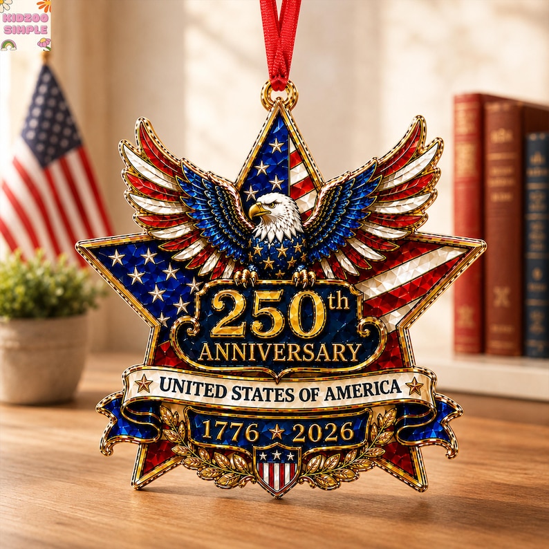 May include: A star-shaped commemorative ornament featuring a bald eagle with spread wings, the text 250th ANNIVERSARY UNITED STATES OF AMERICA, and the years 1776-2026. The design incorporates red, white, and blue colours with gold accents.