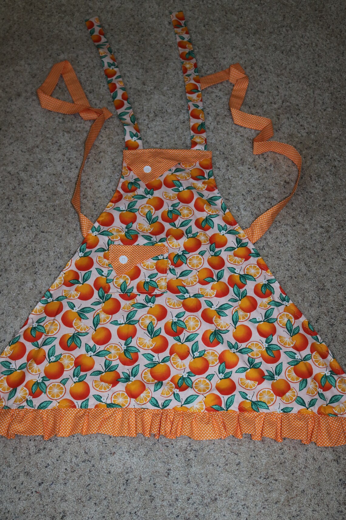 Between the Mountains Orange A feather for each Apron