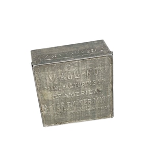 May include: A silver metal box with the text "Vach-No Manufacturing Co. of America. After Dinner Mint" printed on the top.