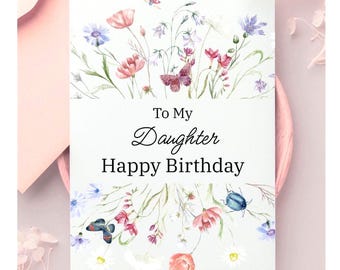 Könnte beinhalten: Geburtstagskarte mit floralem Design, darunter rosa Mohnblumen und blaue Kornblumen. Der Text "To My Daughter Happy Birthday" ist in einer eleganten Schriftart geschrieben.