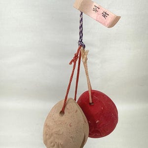 May include: A white ceramic mug with a black handle and the text "But First, Coffee" in a black, handwritten-style font. The mug is on a white surface.