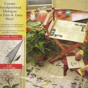 May include: A book cover with a yellow background and the text "Create Handpainted Designs the Fun & Easy Way!"  The cover also features a close-up of a flower design with the text "Simply Trace" and "Lift".