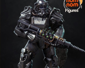 May include: A detailed figurine of a character in dark gray power armor, holding a large weapon with yellow and green accents. The figure has a helmet with a respirator and is standing on a rocky surface. The logo "nom nom Figures" is in the upper right corner.