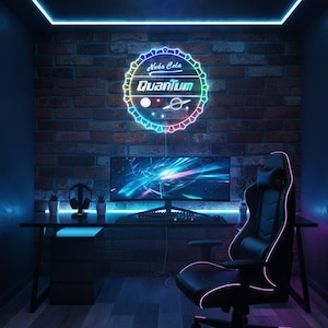 May include: A gaming setup featuring a black desk, a curved monitor, and a black gaming chair with pink accents. A neon sign on the brick wall reads "Nuka Cola Quantum". The room is illuminated with blue and pink neon lights.