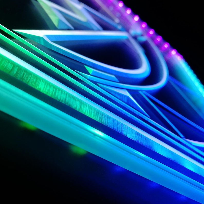 May include: Abstract geometric design with a gradient of blue, green, and purple hues. The artwork features layered lines and shapes, creating a sense of depth and dimension. The design is illuminated with LED lights, adding a modern touch.