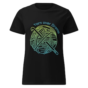 May include: Black t-shirt with a graphic of a ball of yarn and two crossed crochet hooks. The text "Yarn over Drama" is above the yarn ball in a yellow to blue gradient.