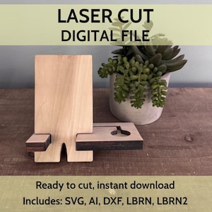 May include: A wooden phone stand with a rectangular base and a vertical back. The stand is light brown with darker brown accents. Text on the image reads "LASER CUT DIGITAL FILE" and "Ready to cut, instant download".