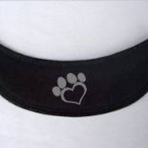 May include: Black dog collar with a gray paw print and heart design.