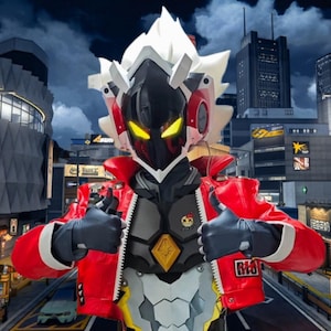 May include: A person in a futuristic robot costume with a red jacket, black gloves, and a helmet with white accents. The costume has a black face with yellow eyes and a silver chest plate. The person gives a thumbs-up.