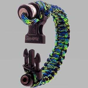 May include: A black and green paracord bracelet with a black metal buckle and a black plastic clasp. The bracelet has the text "Shmokewear" on the buckle.