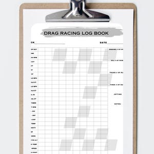 May include: A clipboard with a drag racing log book. The log book has a grid layout with fields for recording data such as date, engine, oil, and tire information. The title "DRAG RACING LOG BOOK" is at the top.
