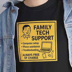 May include: Black t-shirt with a yellow square graphic that reads "FAMILY TECH SUPPORT." The graphic includes a cartoon image of a person, a laptop, a phone, and the words "Computer setup, Phone assistance, Troubleshooting, ALWAYS FREE OF CHARGE."