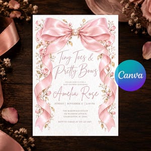 May include: A rectangular baby shower invitation card featuring a large pink satin bow at the top with a pearl center. The card is decorated with pink floral vines and text that reads Tiny Toes & Pretty Bows, Amelia Rose, and event details.