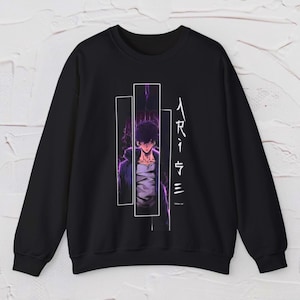 May include: Black sweatshirt with a graphic of a character in a white and purple design. The design includes vertical white rectangles and Japanese text on the right side. The character is wearing a purple jacket and a white shirt.